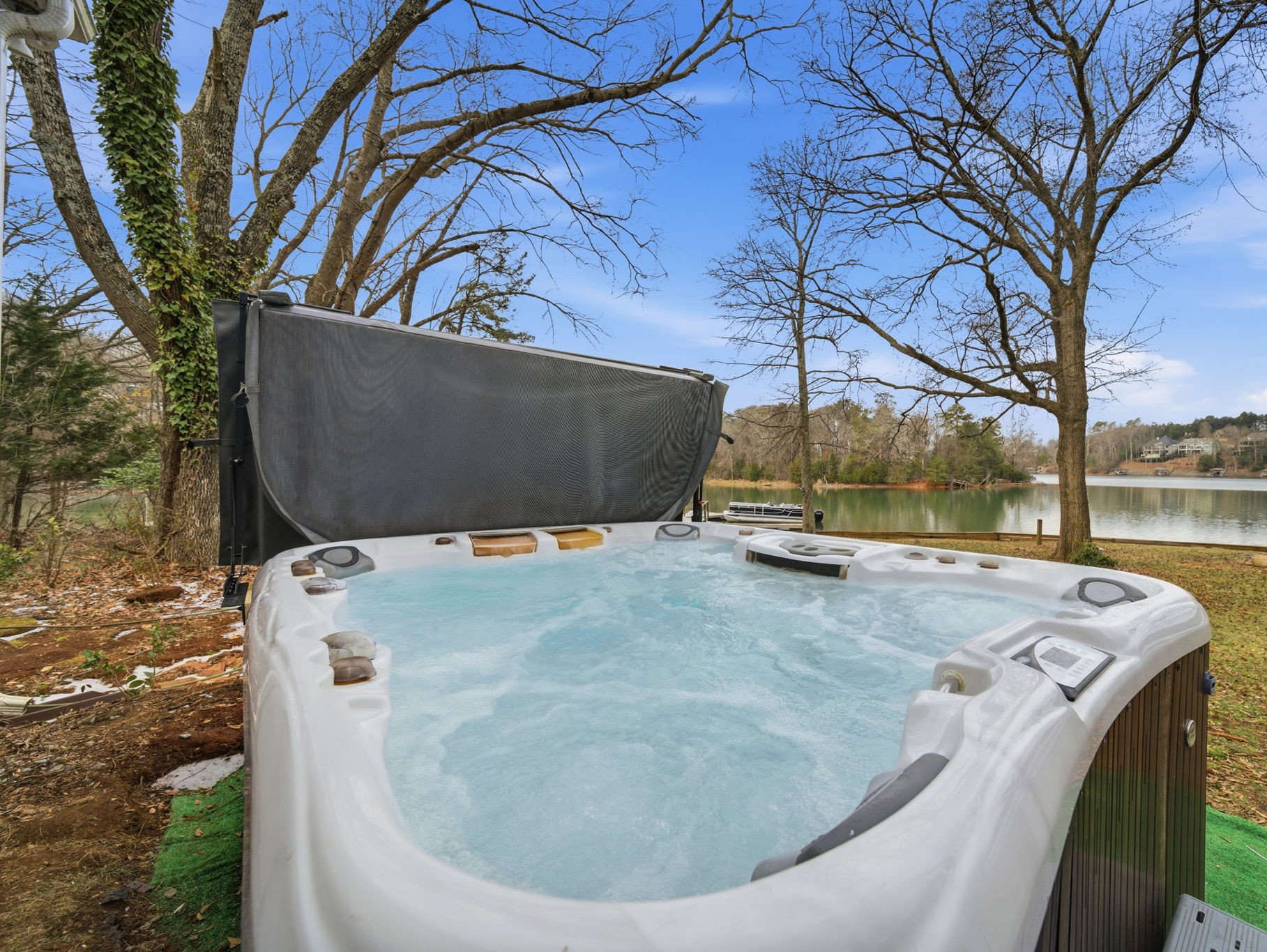 Relax in the hot tub overlooking the lake